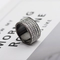 Macro detail of wide titanium steel ring featuring five rows of sparkling inlaid crystals - US 7 / Black