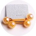 Detail of yellow elastic hair tie with four golden foil amber-like beads on glitter card - 2-Piece Set / Gold