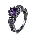 Macro detail of gothic black skull ring with large purple zircon and 18K GP hallmark - US 5 / Black Gold Purple Stone
