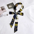 Detail of silk scarf tied in a bow with Egyptian patterns and a glossy finish - Egyptian Horse Black