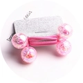 Detailed view of pink crackle beads on an elastic hair tie displayed on a silver card - Pink