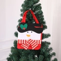 Christmas snowman gift bag made of non-woven fabric hanging on a festive Xmas tree - Snowman