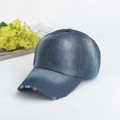 Detailed macro view of vintage washed blue denim baseball cap with orange stitching and distressed edges - Adjustable / Blue Gray