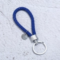 Detail of hand-woven dark blue leather keychain with silver metal ring and engravable tag - Blue