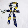 Polka dot skinny silk scarf in blue and yellow with cartoon illustration tied as a bow - Warm Home