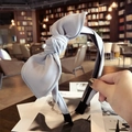 Handheld light grey fabric headband with bow detail for women in a cozy cafe setting - Gray