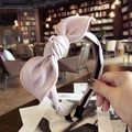 Minimalist pink fabric headband featuring a classic bow design for a stylish women's look - Pink