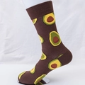 Mid-calf cotton sock in dark brown featuring vibrant avocado food pattern on foot model - EU 41-46 / Coffee (Avocado Pattern)