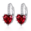 Sparkling heart-shaped red zircon earrings with silver metal pavé setting on white background - Red