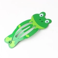 Detail view of a green metal snap clip featuring a cute cartoon frog design for kids - Frog