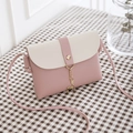 Mini pink and beige crossbody bag with gold deer pendant on checkered background - Pink