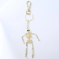 Golden articulated skeleton keychain with polished metal finish and sturdy spring clip - Black Gift Box / Bronze
