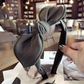Olive green fabric headband with a large structured bow and visible stitching detail - Dark Green