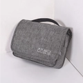 Grey fabric hanging toiletry bag with white cosmetic icons and top handle for travel - Gray