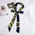 Elegant long skinny scarf featuring colorful striped geometric patterns and silk texture - Geometric Green