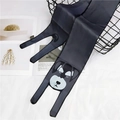 Detail view of black silk skinny scarf with cartoon dog print draped on black metal basket - Coonhound / 120cm