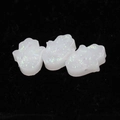 Detailed macro shot of white hamsa hand resin beads with iridescent opal glitter finish - White
