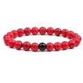 Detail of 8mm red turquoise beaded bracelet with natural texture and black accent bead - Red