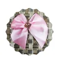 Detailed view of pink satin bow with a square brown gemstone and diamond border - Pink