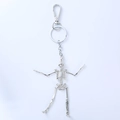 Detailed view of silver skull keychain with movable limbs and spring hook mechanism - Black Gift Box / Silver