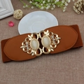 Brown elastic corset belt for women featuring golden cat-eye stone buckle - Camel