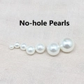 Detailed view of mixed size white non-perforated pearls with iridescent luster - Non-porous Pearl / Diameter 4mm