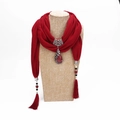 Detail of red tassel scarf with large peacock metal pendant and stone inlays - Burgundy
