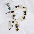 Cream silk scarf with medal prints and smooth texture tied in a knot for handbag handle - 23 Badge