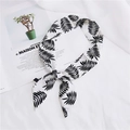Narrow white silk scarf with black leaf pattern tied in a bow on a serene background - 28 Mimosa