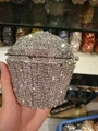 Close-up of a silver cupcake-shaped evening clutch bag covered in sparkling crystals - Silver