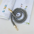 Detail of grey twisted shoulder strap with gold lobster clasps on plain background - Gold Buckle / Gray