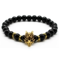 Macro shot of men's lava stone bracelet featuring a golden dragon charm on white background - Glossy Black / Gold