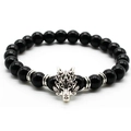 Detailed view of silver dragon charm bead on a black volcanic stone stretch bracelet - Glossy Black / Silver
