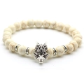 Close-up of men's stone bead bracelet with silver wolf head charm and brown crackle beads - White Turquoise / Silver