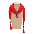 Red ethnic tassel scarf with peacock gemstone pendant on mannequin display - Red