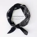 Square silk scarf with black and white paisley pattern tied in a stylish ring knot - Paisley Black