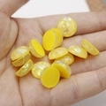 Detailed view of 12mm yellow synthetic opal resin cabochons with glitter foil effect - Yellow with Sequins (7)