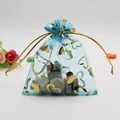 Detailed view of a blue organza jewelry pouch with gold heart prints and a silk drawstring - Lake Blue