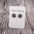 Detail view of snowflake stud earrings with crystals on a jewelry display card - White FJ Pattern (Earring Card) / 5x7cm