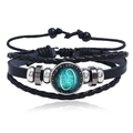 Detail of multi-layer black leather bracelet with glowing Cancer zodiac glass charm - Cancer