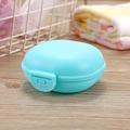Portable light blue travel soap box with lid and secure latch on a wooden background - Blue