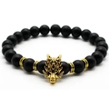 Men's volcanic stone bracelet featuring black matte beads and a golden wolf head charm - Matte Black / Gold