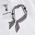 Narrow silk scarf with floral geometric patterns tied in a knot on white fabric background - 27 Flower Leaf Green