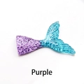 Macro shot of glittery purple-blue gradient mermaid tail resin charms for DIY crafts - Purple