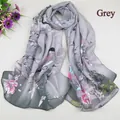 Close-up of floral and bird print on semi-transparent grey chiffon scarf for women - Gray