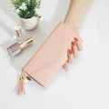Pink long envelope wallet for women featuring elegant heart charm and leather tassel - Nude Pink