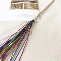 Detail of colorful metallic tinsel cat teaser wand with sequins and silver bell - Rainbow