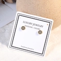 Golden Evil Eye stud earrings with blue and white crystals on a jewelry card - Gold (ED558)