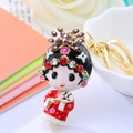 Sparkling Peking Opera character keychain with colorful rhinestones and gold metal finish - Red Opera Actress