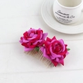 Detail of deep pink velvet rose hair combs with golden metal teeth on white wood - Violet